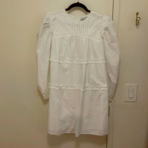 Valencia & Vine white mini dress with ruffle detail.